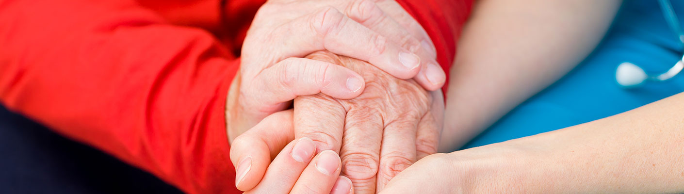 caregiver and homeland patient holding hands