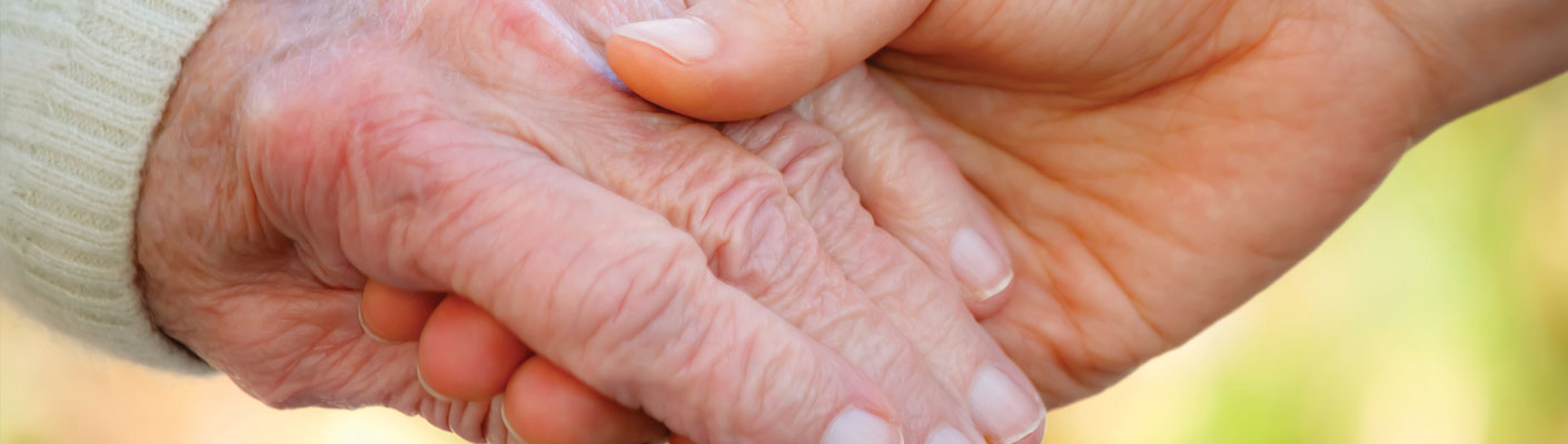 caregiver and homeland patient holding hands