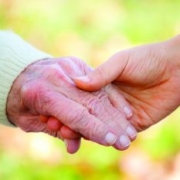 nurse and resident holding hands