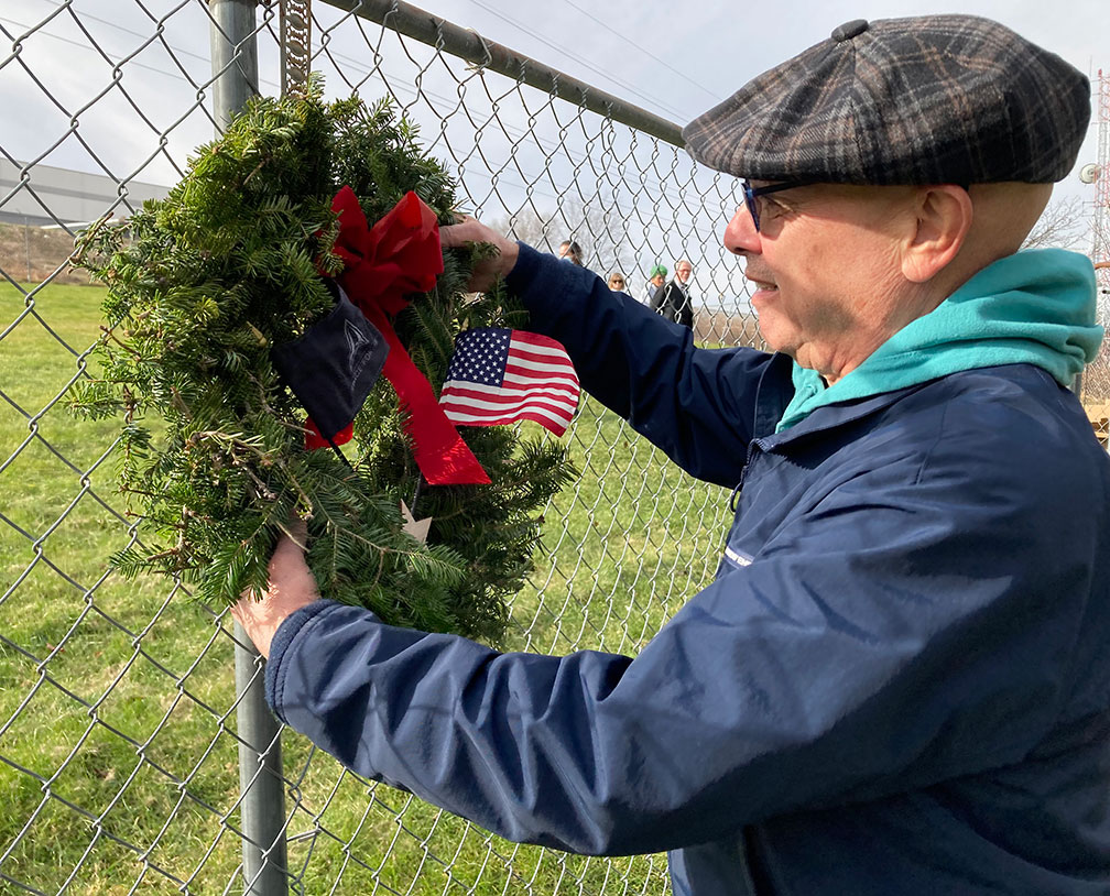 hanging a wreath to honor veterans